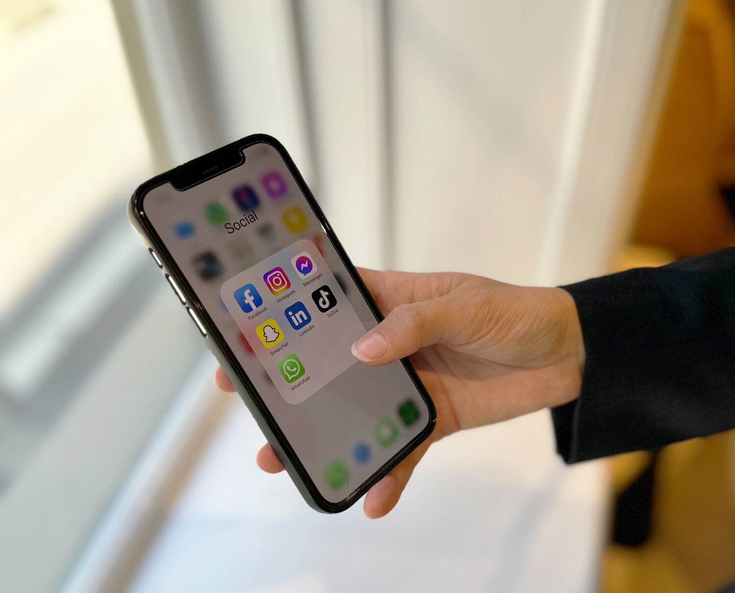 telefon med oversikt over ulike sosiale medier som apper